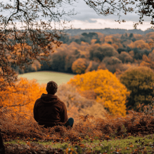 A person enjoying a colorful autumn landscape, looking content and relaxed.