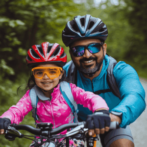 Families cycling together on Ancaster’s scenic trails, wearing bright clothing and properly fitted helmets, enjoying summer’s fresh air.